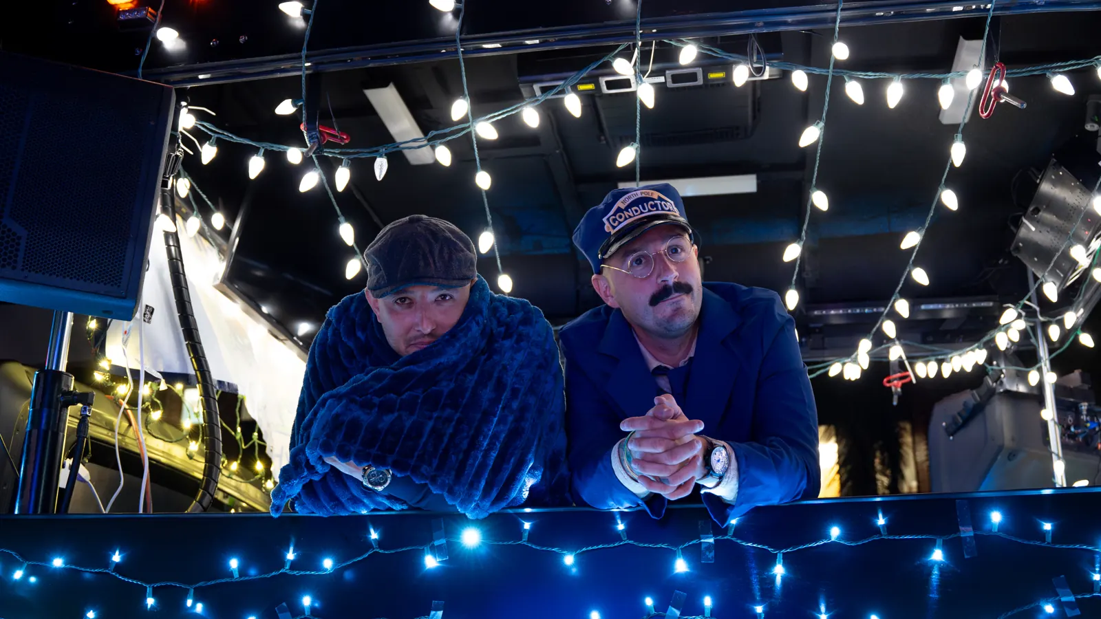 Two of the FoxHaven crew on their float in the Stuart Christmas Parade, covered in blue lights