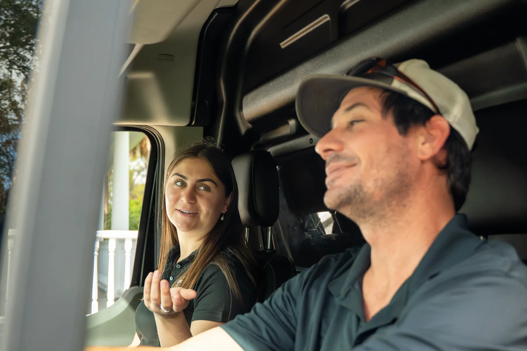 Two of the crew talking in the front seats of the van