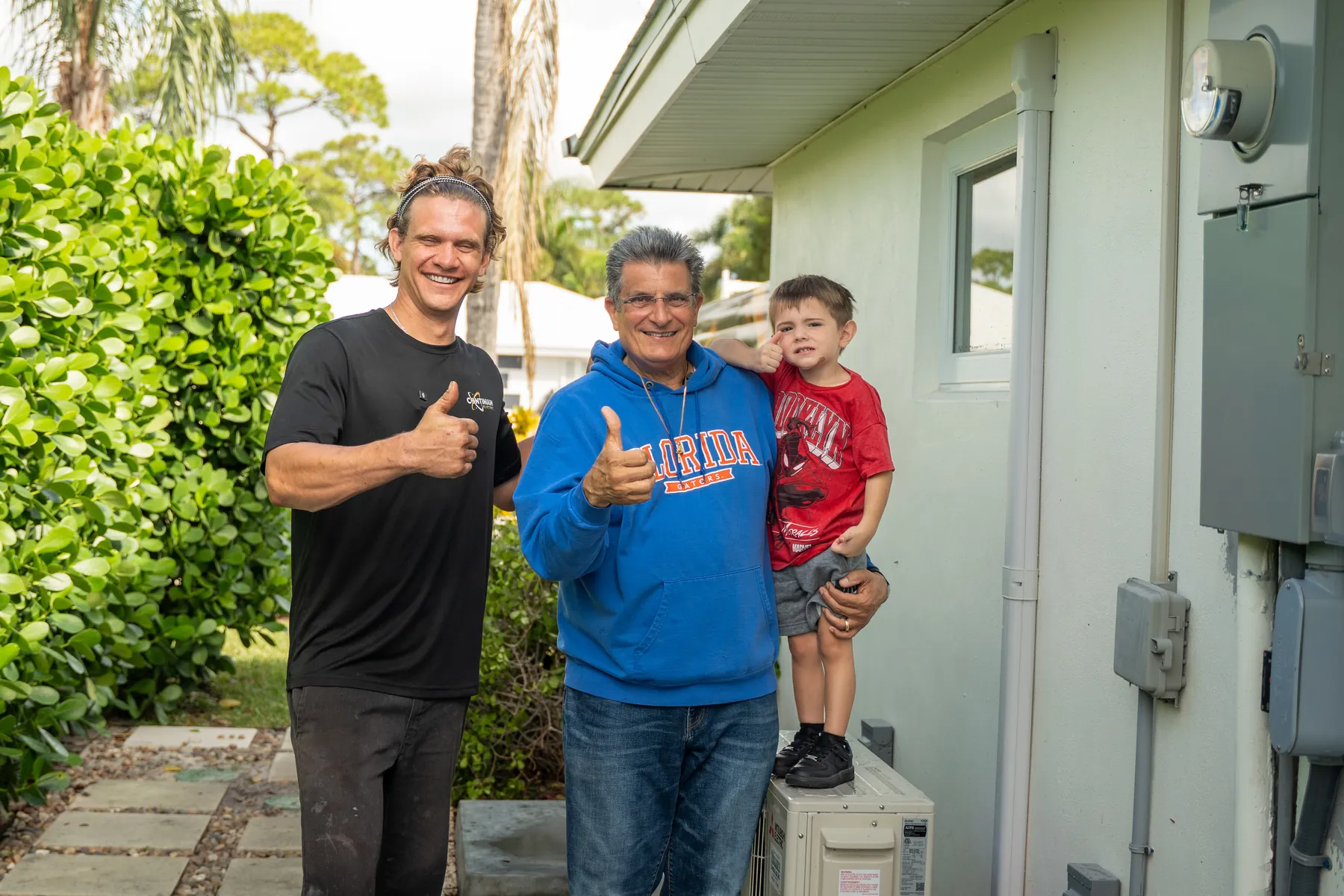 The owner with a homeowner and his son after a panel upgrade