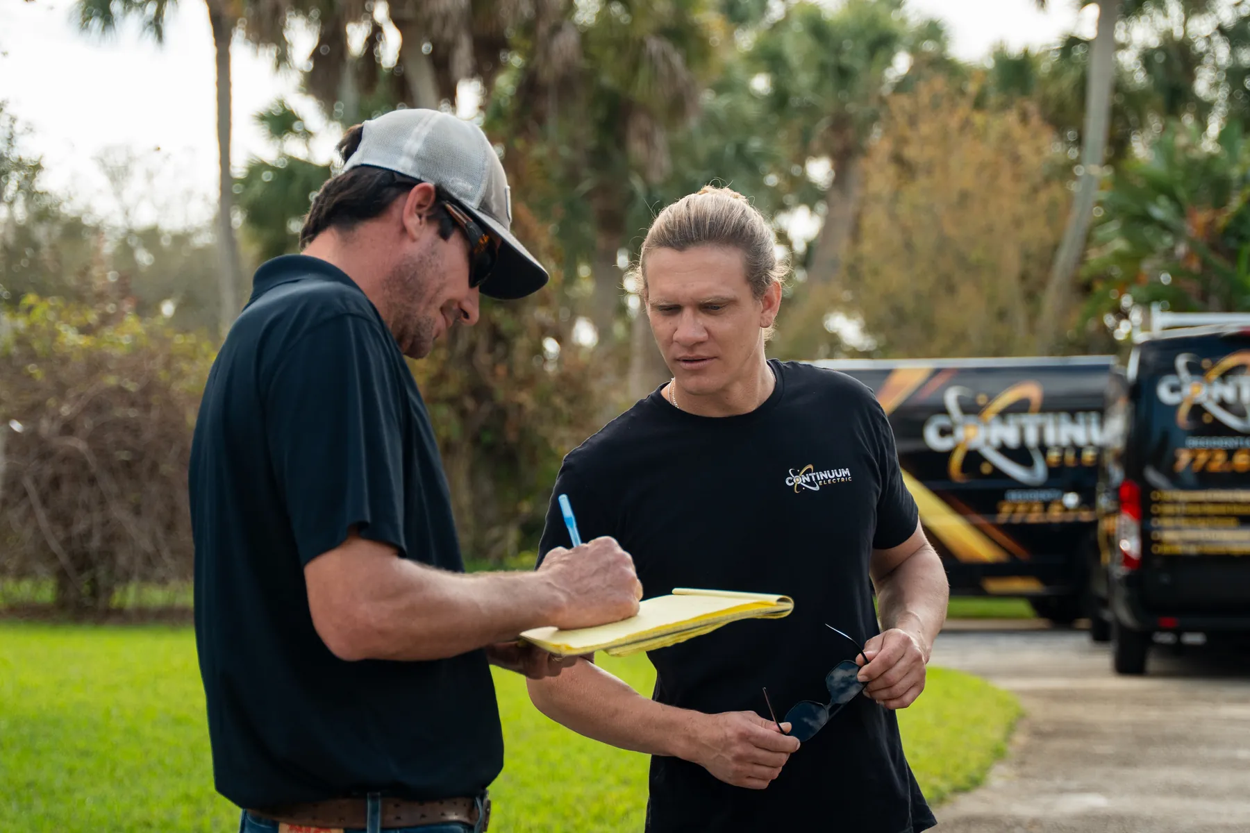 Two of the crew planning a job in a driveway