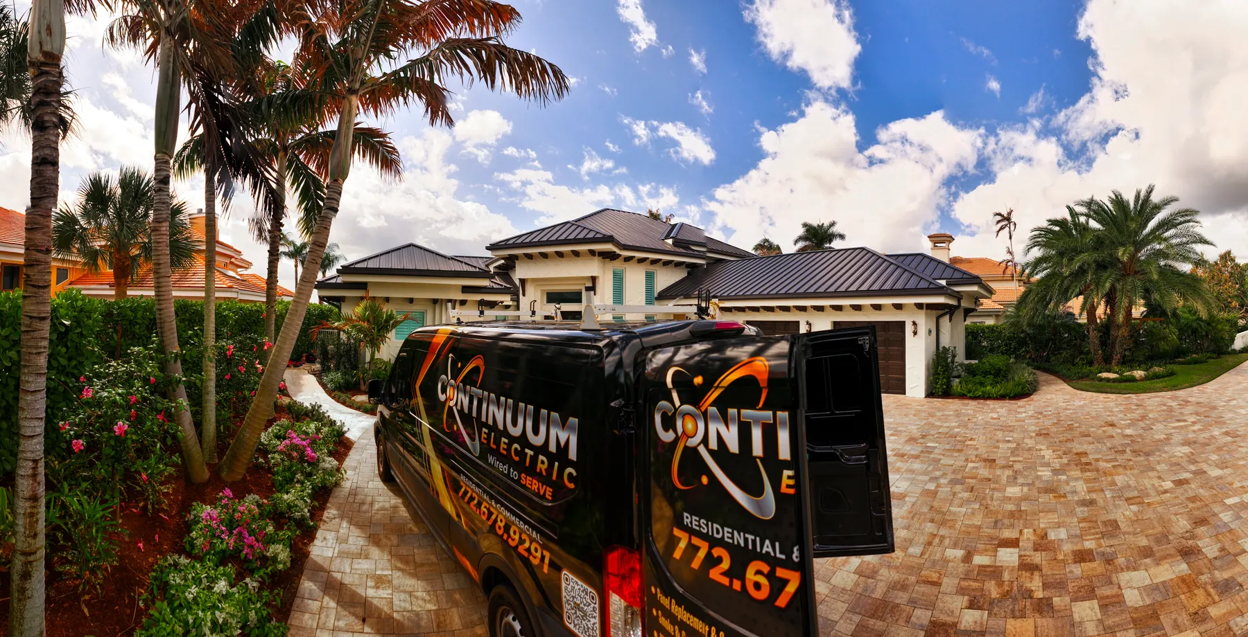 The Continuum van parked outside a large home with palm trees