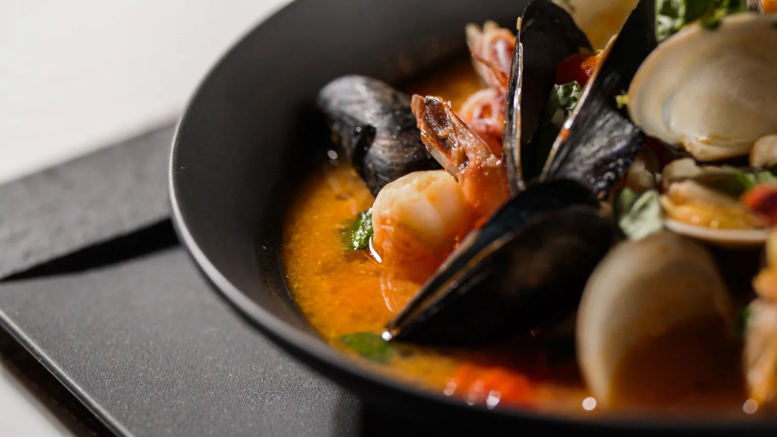 Mussels, clams and shrimp in a red broth