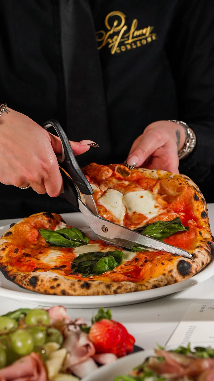 A pizza being cut at the table