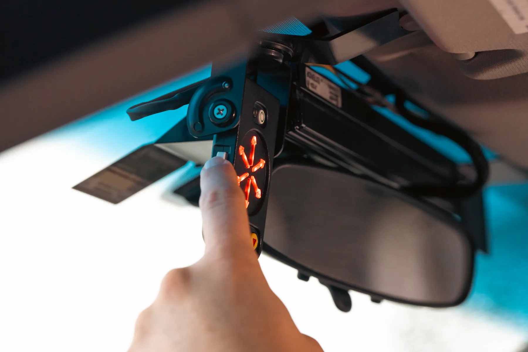 A finger pressing the StopAmbush display as its arrows light up